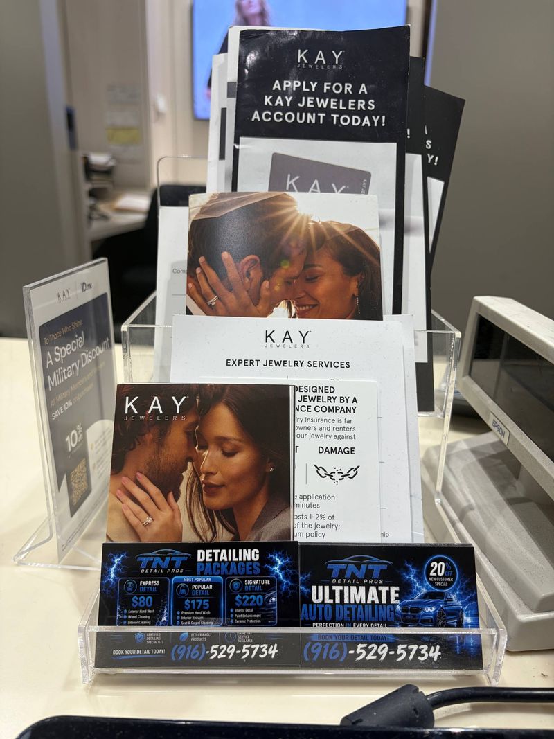 TNT Detail Pros business cards in a holder at the Kay Jewelers counter