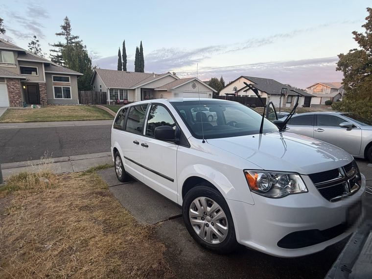 White Dodge minivan parked in a driveway