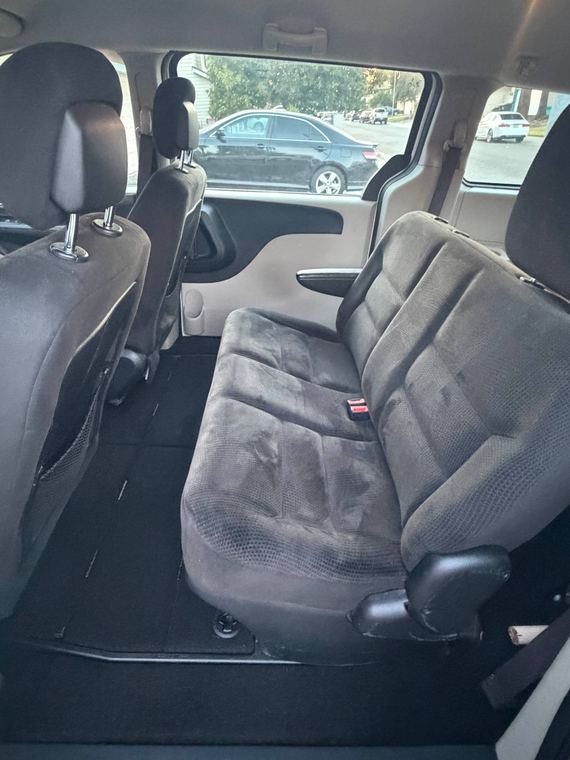 Rear bench seat of a minivan with dark cloth upholstery
